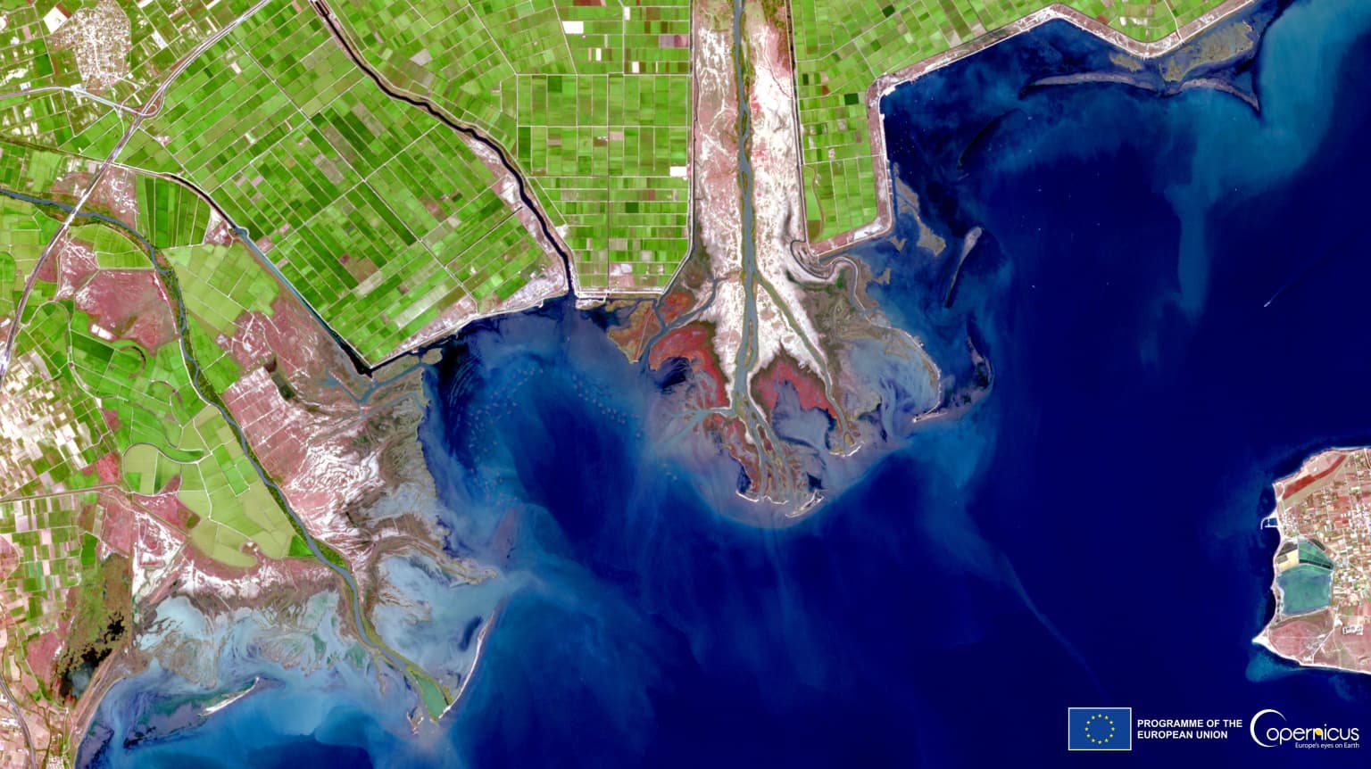 Satellite image of Axios Delta National Park in Greece with river deltas, coastal wetlands, agricultural fields, and urban areas