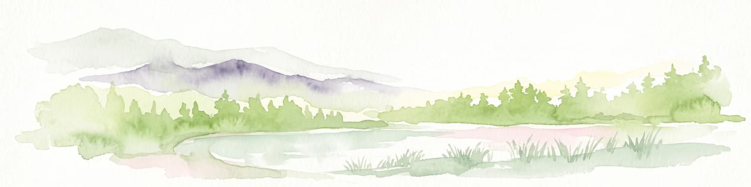 A watercolor painting showing a quiet lakeside scene with dense green forests in the background and soft, purplish mountains rising behind them.