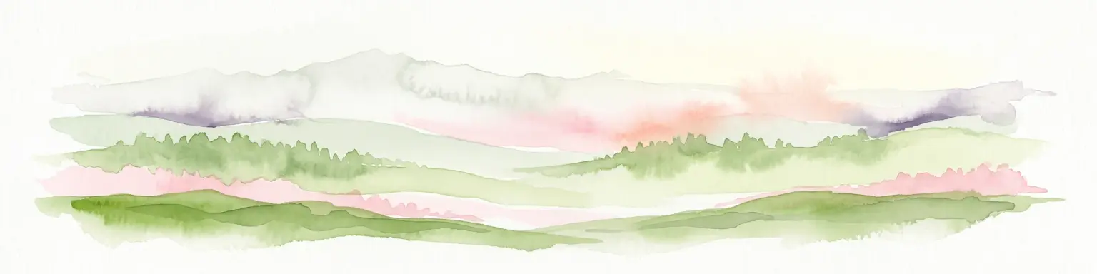 A horizontal watercolor painting depicting a soft-toned mountain range with layered green hills and distant, hazy peaks in pastel pink and purple hues.