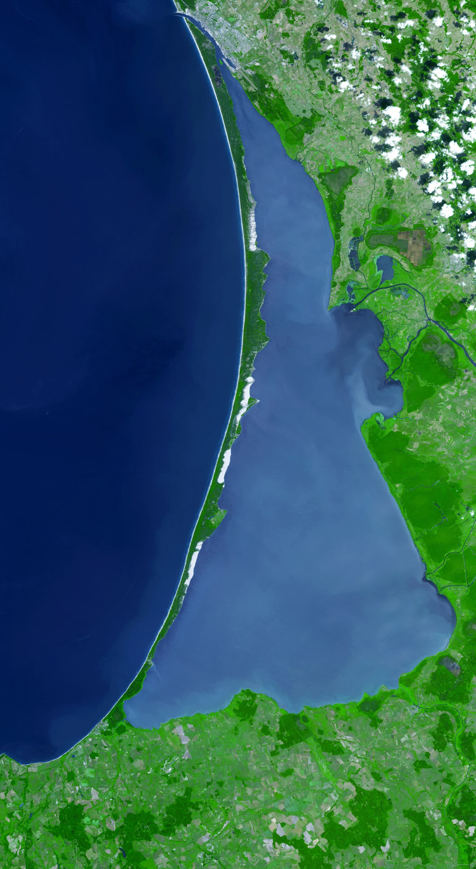 Satellite image showing the Curonian Spit as a narrow landmass between the Baltic Sea and Curonian Lagoon