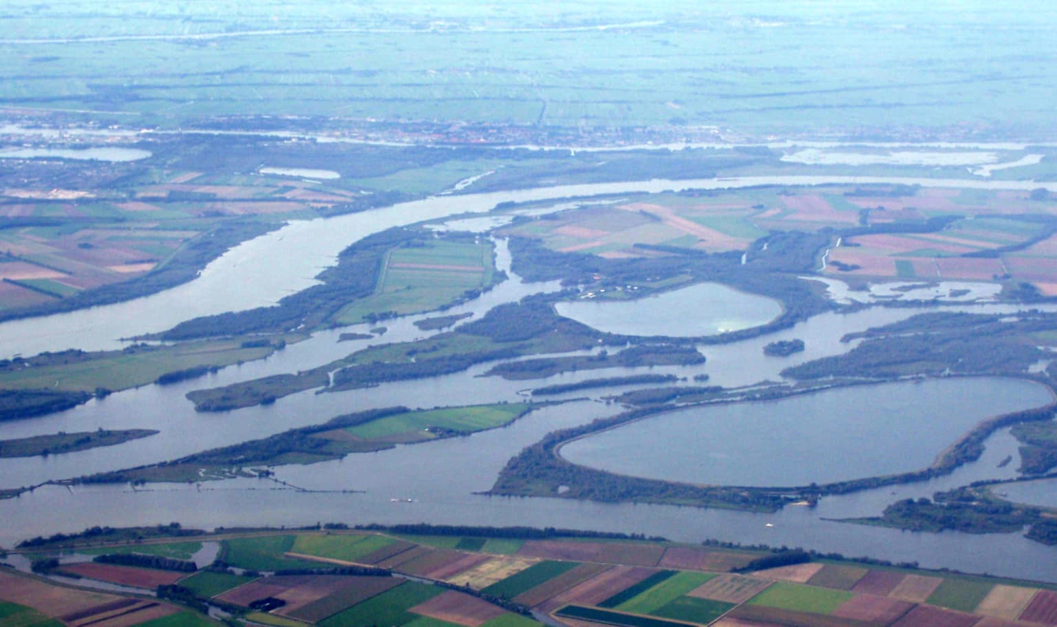 Aerial photograph of De Biesbosch National Park with a network of rivers and wetlands surrounded by agricultural fields