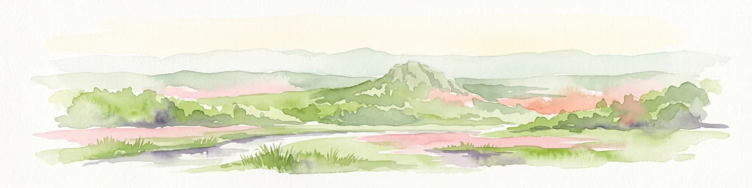 A horizontal watercolor painting showing rolling green hills and a small stream in the foreground with faint mountain ridges in the distance.