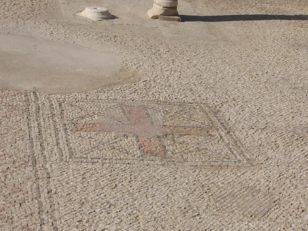 Close-up of ancient mosaic floor featuring a central cross, part of Mamshit National Park