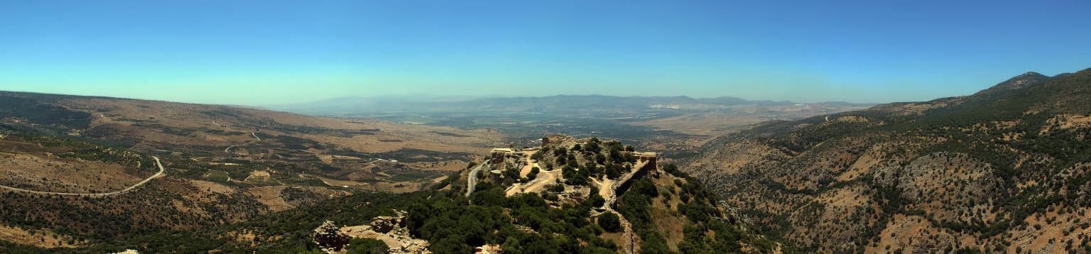 Nimrod Fortress on a hilltop with surrounding mountainous landscape under clear blue sky