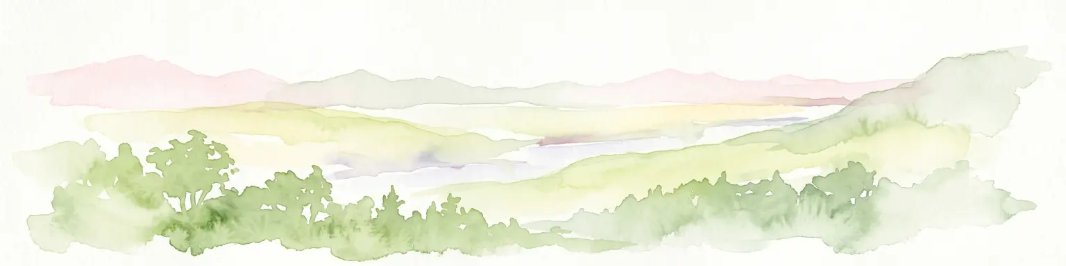 A soft watercolor painting of rolling green hills and a distant mountain range on a white background.