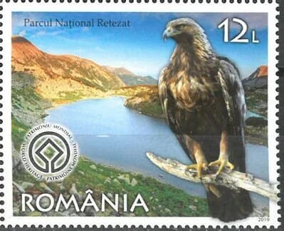 Romanian stamp showing Retezat National Park with a golden eagle perched on a branch, mountains and lake in background, and Romanian text