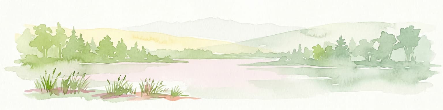 Watercolor painting of a lake surrounded by trees and hills under a pale sky