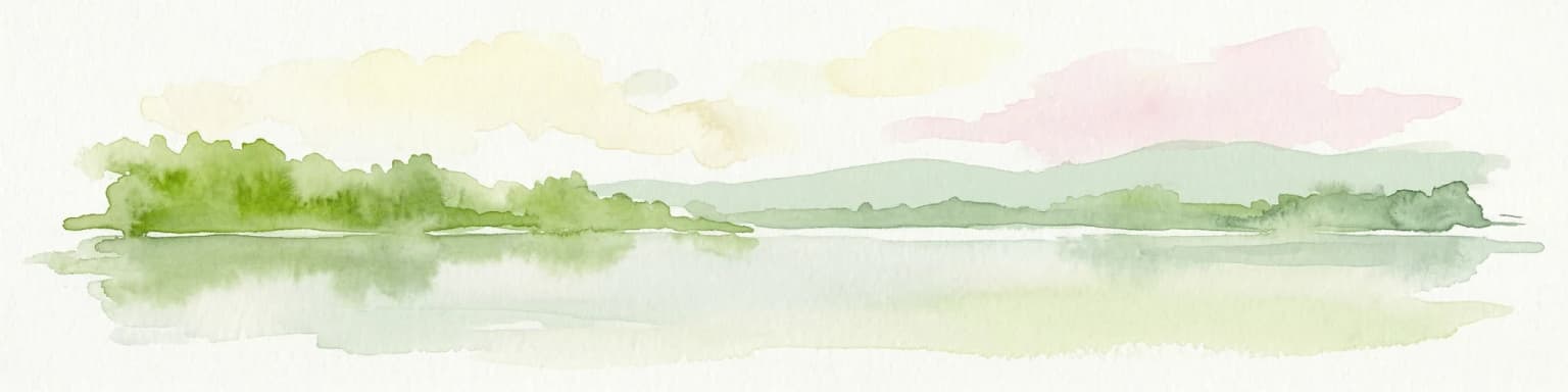 Watercolor painting of a lake with green forested islands and distant mountains under a pastel sky