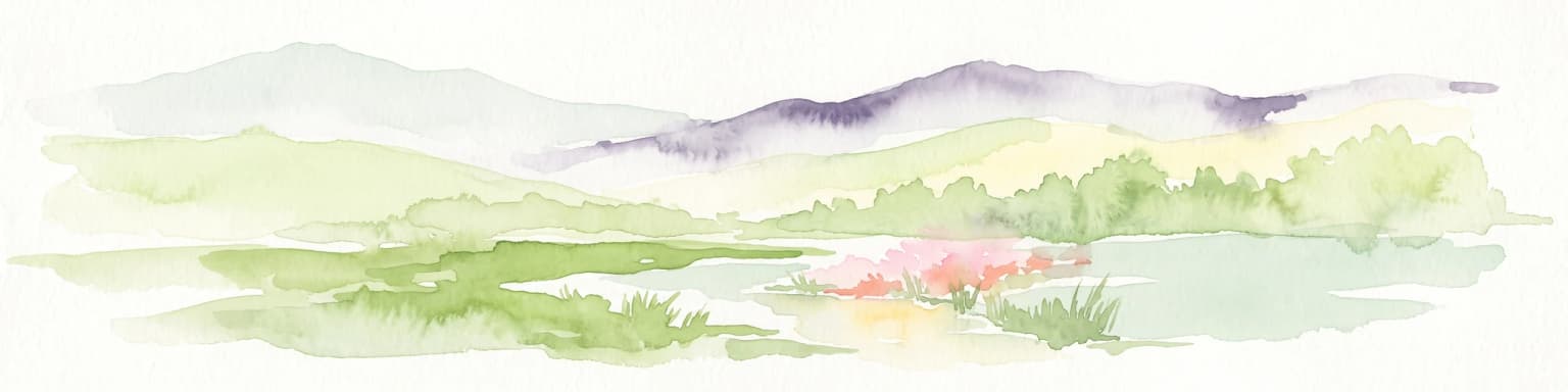 Watercolor painting of a soft landscape with distant purple and grey hills, green fields, trees, and a small pinkish flower cluster near a small pool of water.
