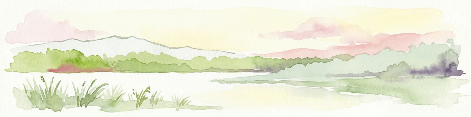 Watercolor painting depicting a lake, grassy foreground, and mountains under a pink and yellow sky